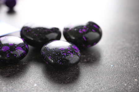 Black beads on grey background, closeupの写真素材