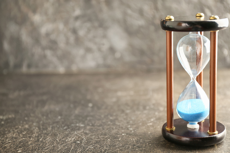 Hourglass on grey background. Time management concept