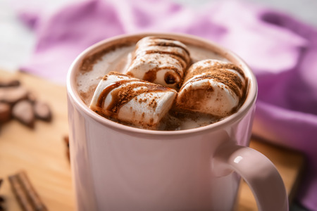 Cup of tasty cocoa drink with marshmallow, closeup