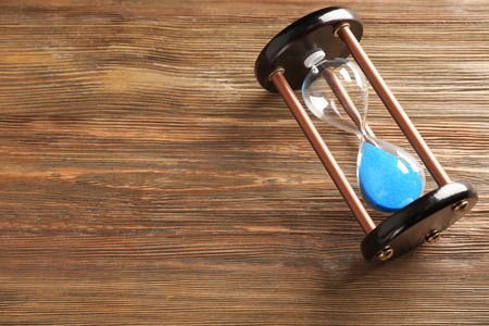 Hourglass on wooden table. Time management concept
