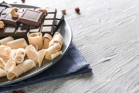 Plate with dark and white chocolate on tableの写真素材