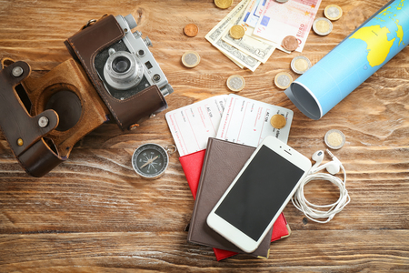 Composition with world map, passports and mobile phone on wooden table. Travel planning conceptの写真素材