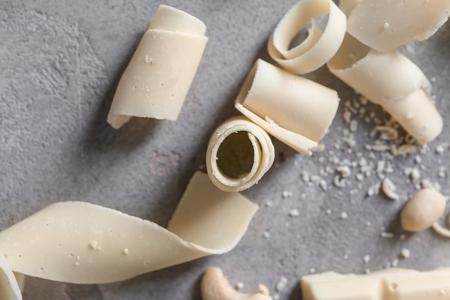 White chocolate curls on grey background, closeupの写真素材