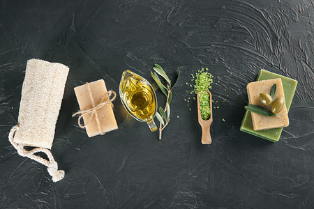 Composition of natural soap with olive extract on table