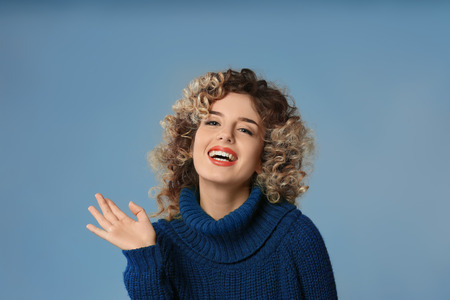 Portrait of beautiful young woman on color backgroundの写真素材