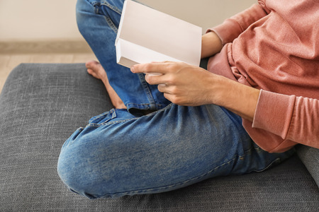 Man reading interesting book at home