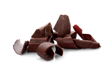 Pieces of chocolate with curls, isolated on white