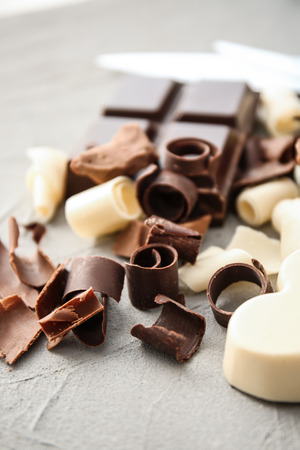 Pieces of chocolate with curls on grey backgroundの写真素材