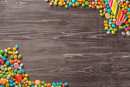 Colorful candies on wooden backgroundの写真素材