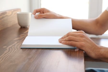Man reading interesting book at homeの写真素材