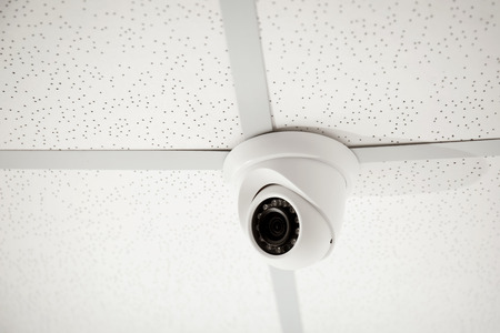 Modern CCTV security camera installed indoorsの写真素材