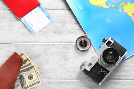 Composition with map, camera,money and passport on wooden background. Travel conceptの写真素材