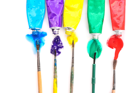 Painter's brushes and tubes with oil paints on white backgroundの写真素材
