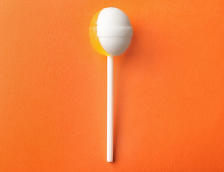Tasty sweet lollipop on color backgroundの写真素材