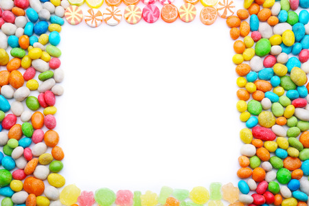 Frame made of colorful candies on white backgroundの写真素材
