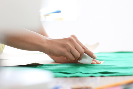 Young female tailor working with sewing pattern in atelierの写真素材