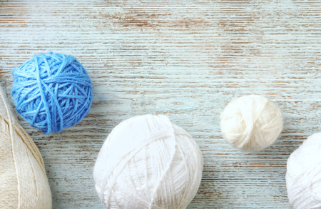 Balls of knitting yarn on wooden background, top viewの写真素材