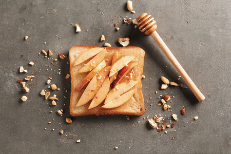 Delicious toast with pear and honey on grey backgroundの写真素材
