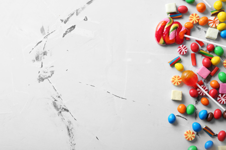Different candies on color background, top viewの写真素材