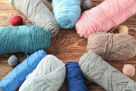 Colorful knitting yarn on wooden background