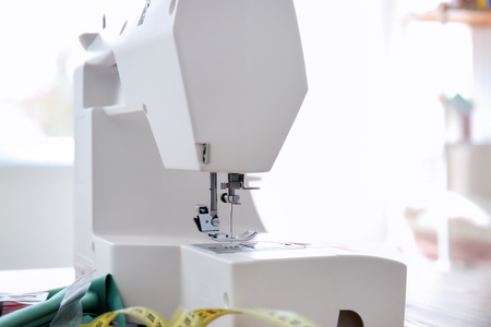 Sewing machine on table in tailor's workshopの写真素材