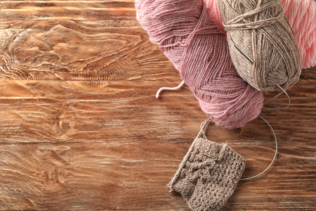 Knitting yarn on wooden backgroundの写真素材