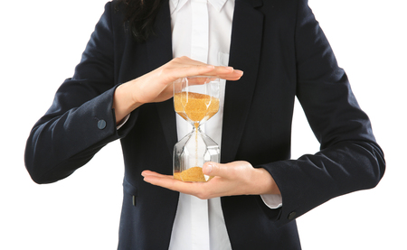 Woman holding hourglass on white background. Time management concept