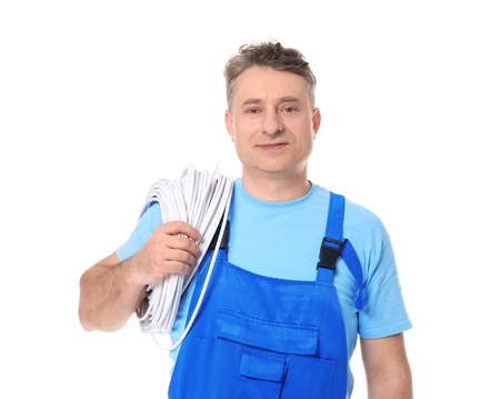 Mature electrician with wires on white background
