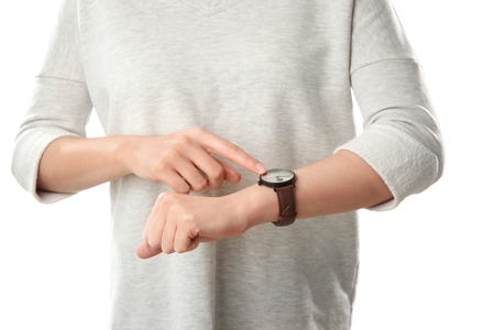 Woman looking at watch on white background. Time management conceptの写真素材