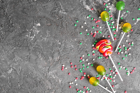 Colorful candies on grey textured background, top viewの写真素材