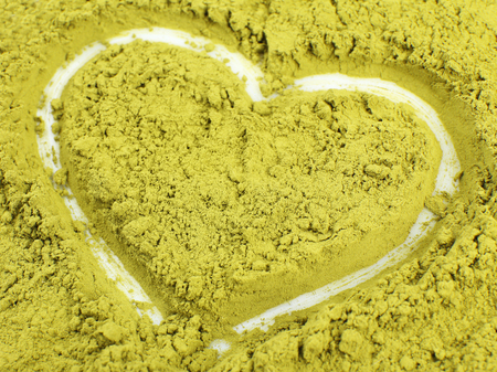 Powdered matcha tea with heart shape, closeupの写真素材