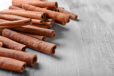 Cinnamon sticks on wooden background