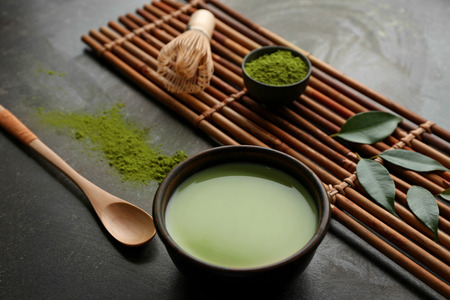 Bowl with matcha tea on tableの写真素材