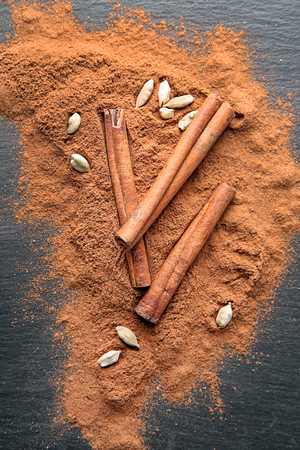 Composition with cinnamon powder on grey backgroundの写真素材