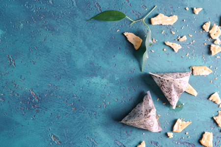 Used tea bags and cookie crumbles on tableの写真素材