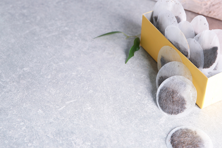 Box with tea bags on tableの写真素材