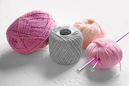 Color knitting yarn with needles on textured backgroundの写真素材