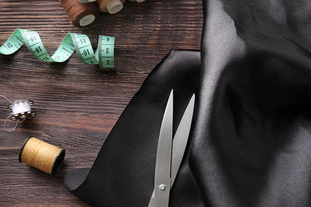 Fabric and sewing accessories on wooden backgroundの写真素材