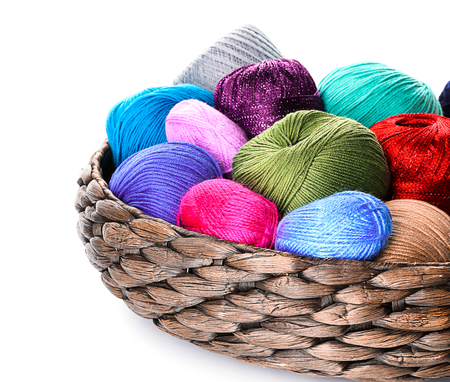 Wicker basket with knitting yarn on white backgroundの写真素材