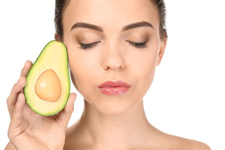 Beautiful young woman with avocado on white backgroundの写真素材