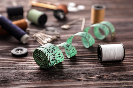 Sewing accessories on wooden backgroundの写真素材