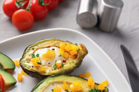 Baked avocado with eggs on plate, closeupの写真素材