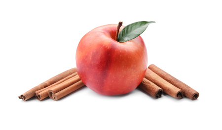Fresh apple and cinnamon sticks on white backgroundの写真素材