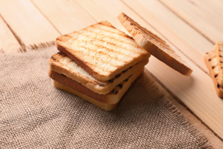 Tasty toasted bread on wooden tableの写真素材
