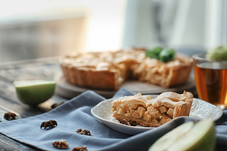 Plate with piece of tasty homemade apple pie on tableの写真素材