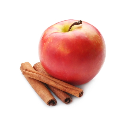 Fresh apple and cinnamon sticks on white backgroundの写真素材