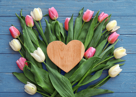 Composition with beautiful tulips and heart on wooden backgroundの写真素材