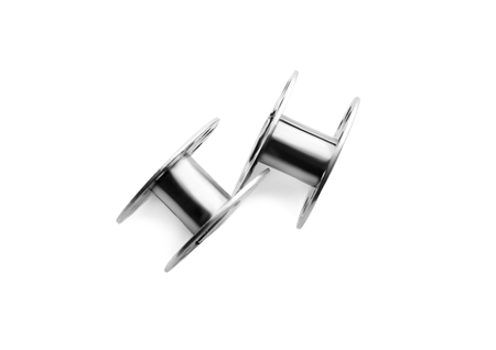 Metal spools for thread on white background