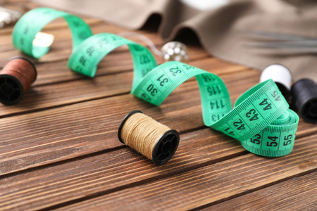 Sewing accessories on wooden backgroundの写真素材