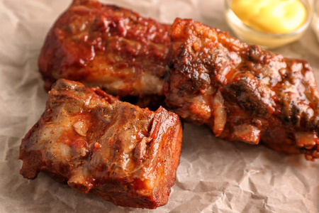 Delicious grilled ribs on parchment, closeupの写真素材